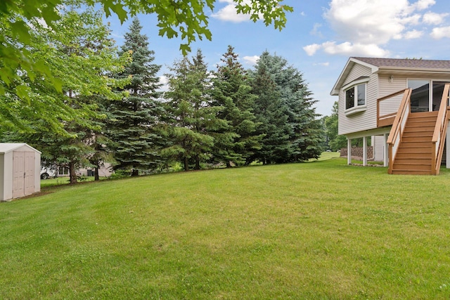 22087 Jasmine Way, Rogers, MN 55374 - view of grassy yard with stairs, a shed, and a deck