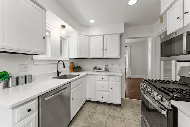 4001 Sheridan Ave S, Minneapolis, MN 55410 - kitchen with appliances with stainless steel finishes, white cabinets, light countertops, and recessed lighting