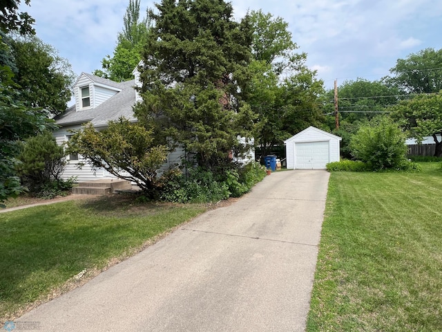 1410 4th St S, Moorhead, MN 56560 - obstructed view of property with an outdoor structure, concrete driveway, a detached garage, and a front lawn