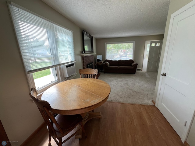 1410 4th St S, Moorhead, MN 56560 - dining area featuring a textured ceiling, wood finished floors, and a fireplace