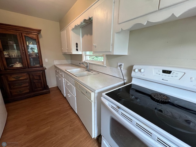 1410 4th St S, Moorhead, MN 56560 - kitchen featuring white appliances, light countertops, white cabinets, and light wood finished floors