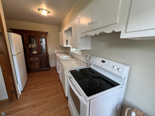 1410 4th St S, Moorhead, MN 56560 - kitchen with white appliances, light countertops, light wood-type flooring, and white cabinets