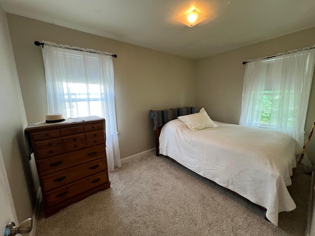 1410 4th St S, Moorhead, MN 56560 - carpeted bedroom featuring baseboards