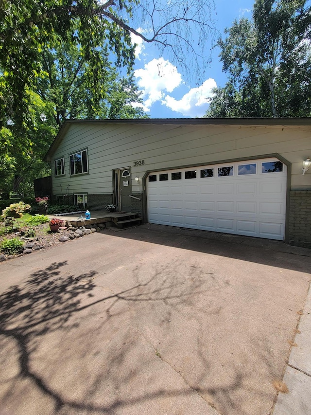 3938 191st Ave NE, Wyoming, MN 55092 - view of front of home with brick siding, driveway, and a garage