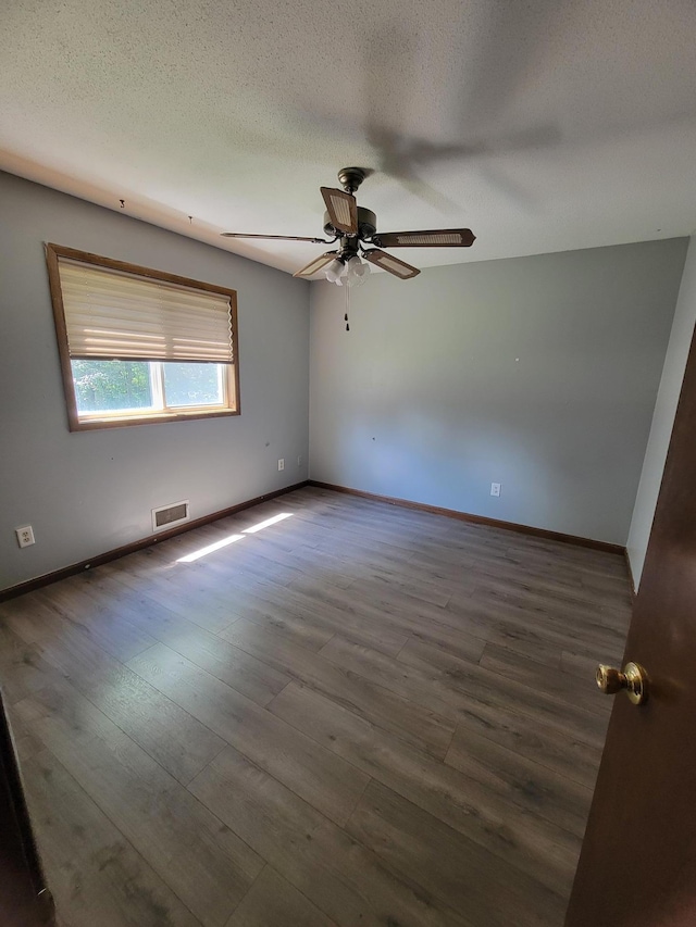 3938 191st Ave NE, Wyoming, MN 55092 - empty room with ceiling fan, wood finished floors, and a textured ceiling