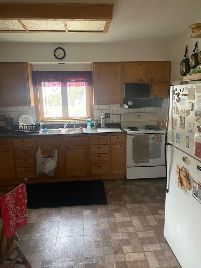 406 N Rd, Cloquet, MN 55720 - kitchen with white appliances, backsplash, and brown cabinetry