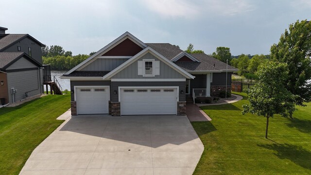 1301 20th Ave S, Sartell, MN 56377 - craftsman-style house with board and batten siding, stone siding, driveway, and a front yard