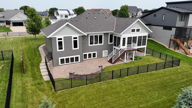 1301 20th Ave S, Sartell, MN 56377 - back of property with stairway, a sunroom, board and batten siding, roof with shingles, and a fenced backyard