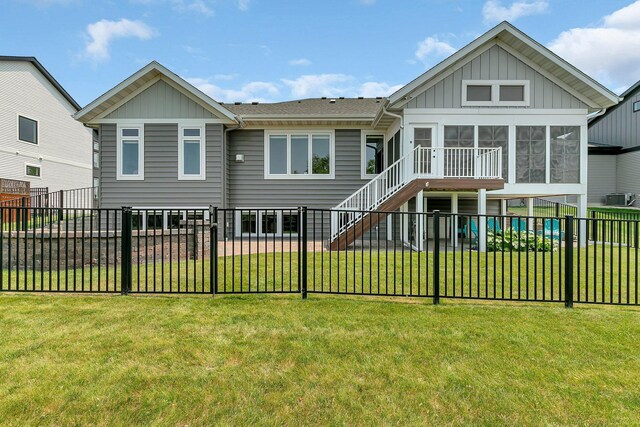1301 20th Ave S, Sartell, MN 56377 - rear view of house featuring a sunroom, board and batten siding, a fenced backyard, and stairway