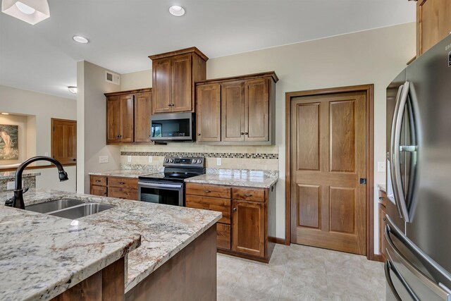 1301 20th Ave S, Sartell, MN 56377 - kitchen with stainless steel appliances, decorative backsplash, and light stone countertops