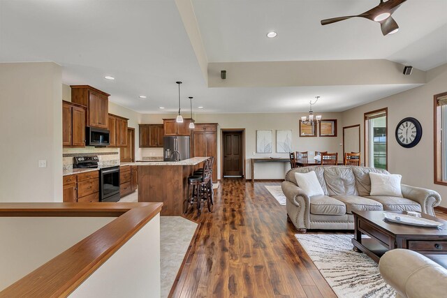 1301 20th Ave S, Sartell, MN 56377 - living room with dark wood-type flooring, a chandelier, recessed lighting, and ceiling fan