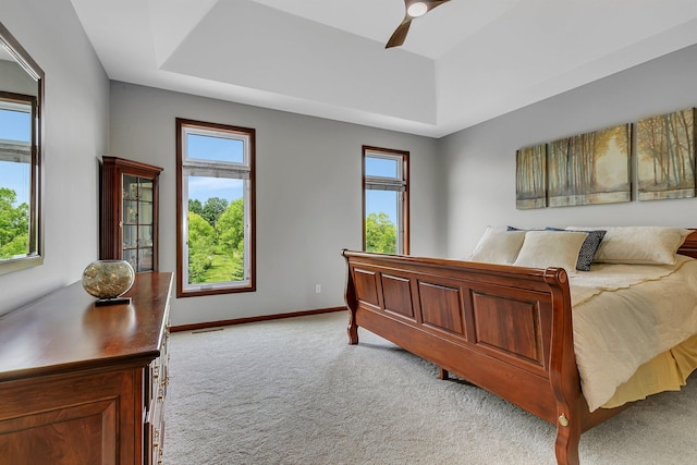 1301 20th Ave S, Sartell, MN 56377 - bedroom with light colored carpet, a raised ceiling, and a ceiling fan