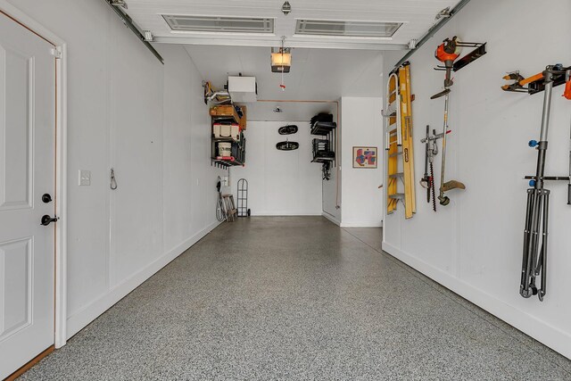 1301 20th Ave S, Sartell, MN 56377 - garage featuring a garage door opener and baseboards