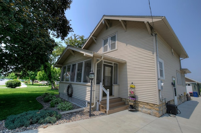 544 7th St, Red Wing, MN 55066 - view of front of house featuring a front yard, a sunroom, and a garage