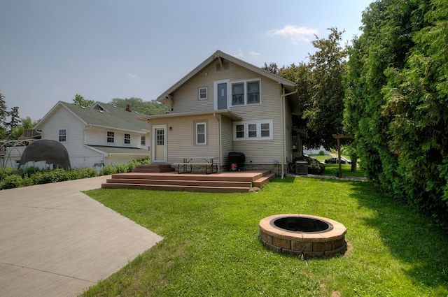 544 7th St, Red Wing, MN 55066 - back of property with a fire pit, a lawn, and a wooden deck