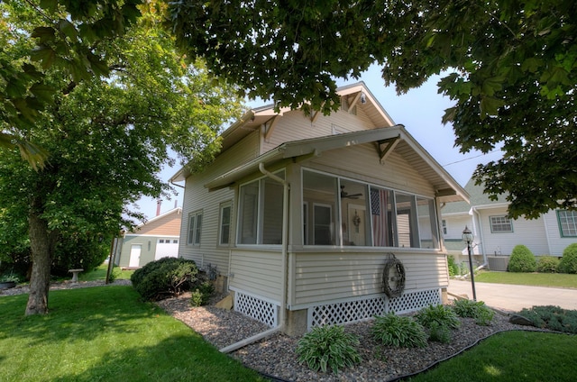 544 7th St, Red Wing, MN 55066 - view of front of property with a sunroom, a front lawn, and a ceiling fan