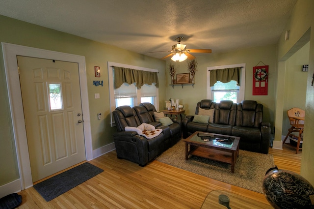 544 7th St, Red Wing, MN 55066 - living area with light wood finished floors, ceiling fan, and a textured ceiling