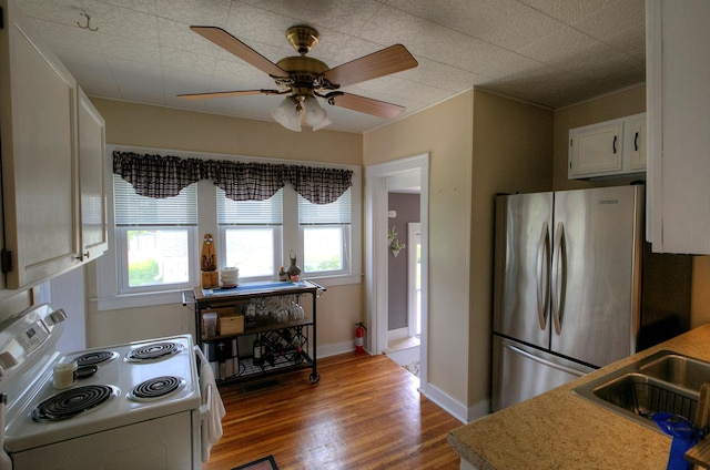 544 7th St, Red Wing, MN 55066 - kitchen featuring electric stove, freestanding refrigerator, plenty of natural light, and wood finished floors