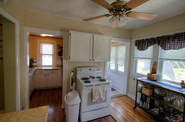 544 7th St, Red Wing, MN 55066 - kitchen featuring electric range, white cabinetry, and plenty of natural light