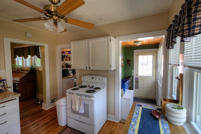 544 7th St, Red Wing, MN 55066 - kitchen with electric stove, wood finished floors, white cabinets, light countertops, and black microwave