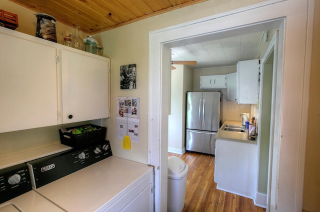 544 7th St, Red Wing, MN 55066 - kitchen featuring freestanding refrigerator, white cabinets, independent washer and dryer, wood finished floors, and wooden ceiling