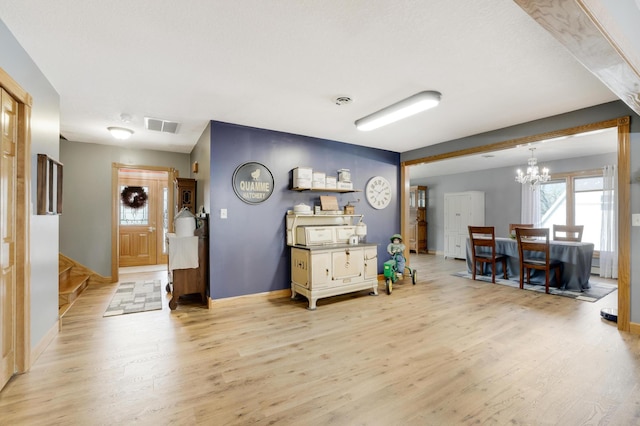 108 1st St, Kenyon, MN 55946 - foyer featuring a chandelier, light wood finished floors, baseboards, and stairs