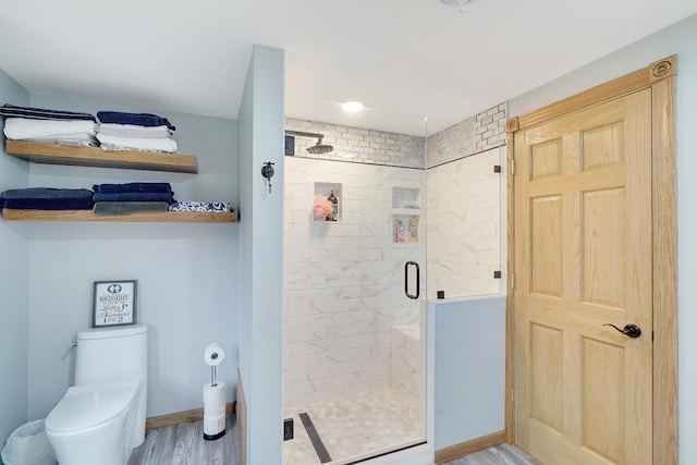 108 1st St, Kenyon, MN 55946 - bathroom with a shower stall, toilet, wood finished floors, and baseboards
