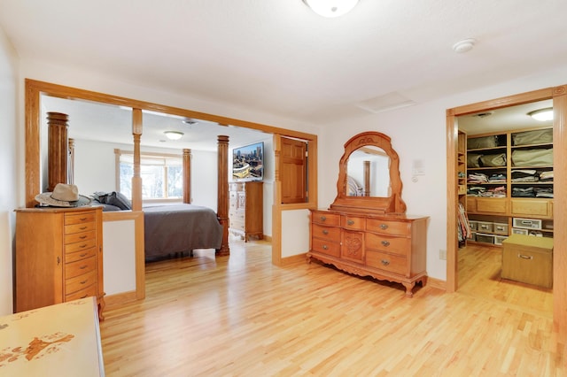 108 1st St, Kenyon, MN 55946 - bedroom with light wood finished floors, decorative columns, baseboards, and a spacious closet
