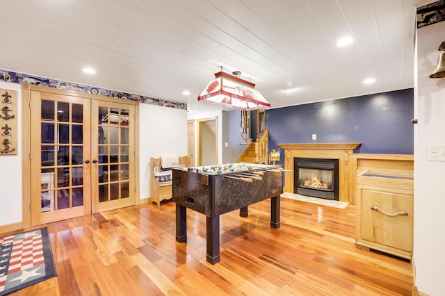 108 1st St, Kenyon, MN 55946 - recreation room with french doors, wood finished floors, a fireplace with flush hearth, and recessed lighting