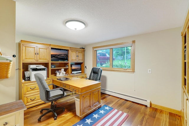 108 1st St, Kenyon, MN 55946 - office with a baseboard heating unit and light wood-style flooring