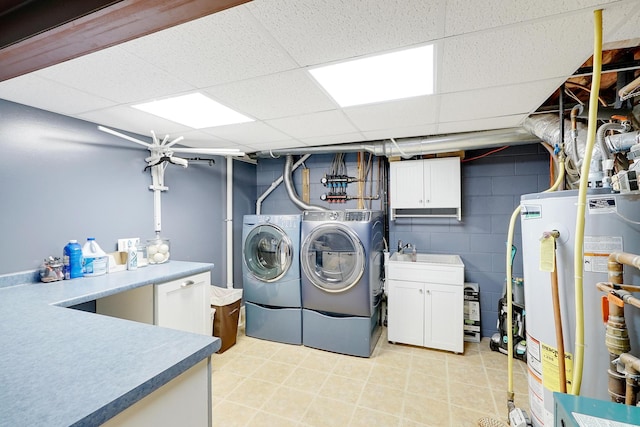108 1st St, Kenyon, MN 55946 - laundry area with independent washer and dryer, cabinet space, water heater, and concrete block wall