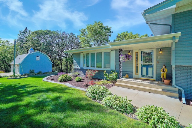 108 1st St, Kenyon, MN 55946 - view of front of property with brick siding and a front yard