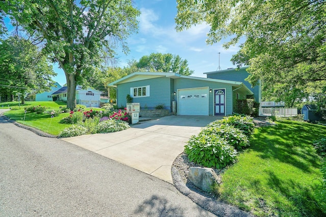 108 1st St, Kenyon, MN 55946 - view of front of house with a garage, driveway, and a front yard
