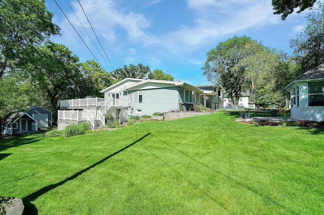 108 1st St, Kenyon, MN 55946 - view of grassy yard featuring a wooden deck and stairs