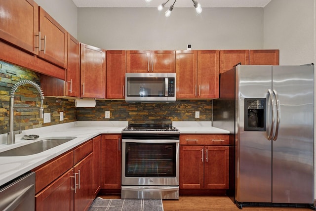 308 18th St Unit 202, Minneapolis, MN 55404 - kitchen with stainless steel appliances, tasteful backsplash, and light wood-style flooring