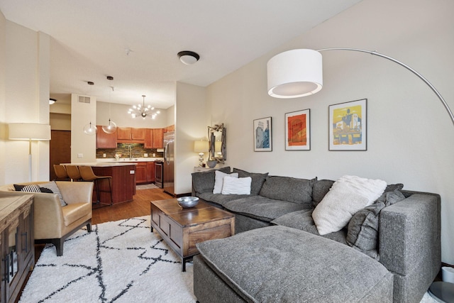 308 18th St Unit 202, Minneapolis, MN 55404 - living area featuring a chandelier and light wood-style flooring