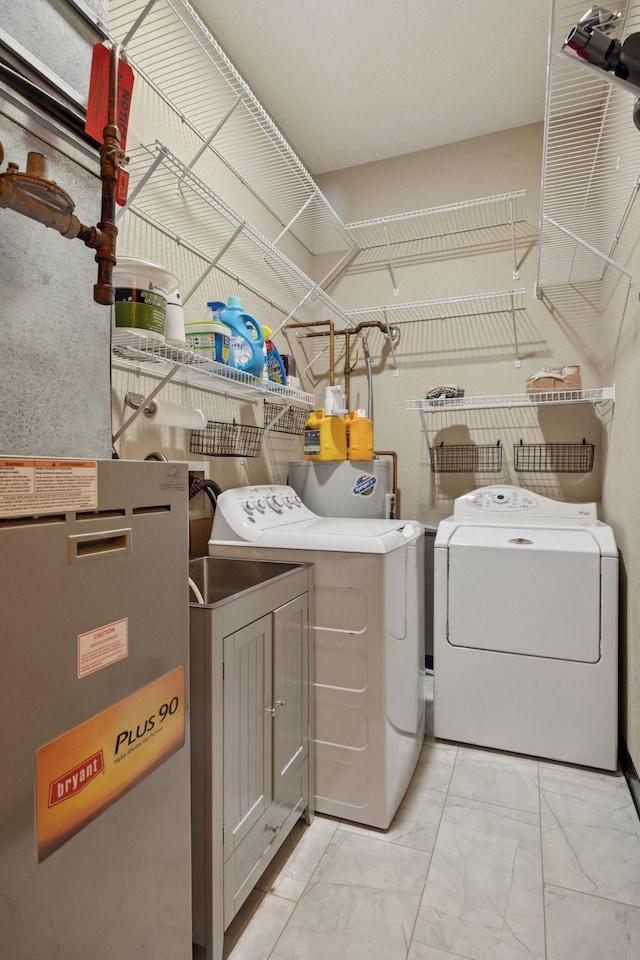 308 18th St Unit 202, Minneapolis, MN 55404 - washroom featuring washing machine and clothes dryer and light marble finish floors