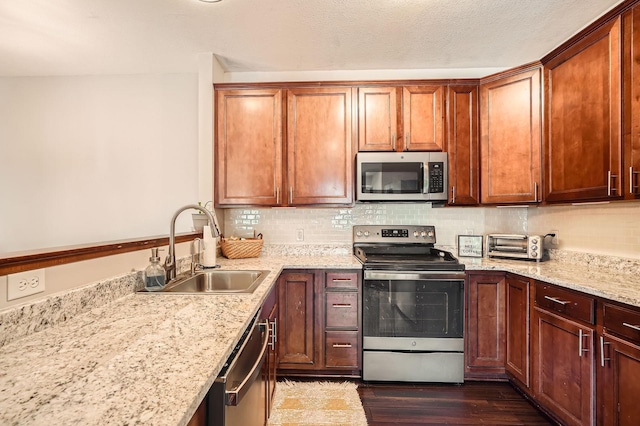 12693 Collegeview Dr Unit 201, Eden Prairie, MN 55347 - kitchen featuring appliances with stainless steel finishes, dark wood finished floors, tasteful backsplash, light stone countertops, and a peninsula