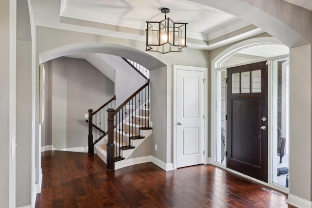 3365 Osgood Way N, Baytown Twp, MN 55082 - foyer entrance with hardwood / wood-style flooring, ornamental molding, a raised ceiling, arched walkways, and a chandelier