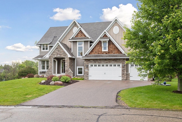 3365 Osgood Way N, Baytown Twp, MN 55082 - craftsman inspired home featuring stone siding, asphalt driveway, a front lawn, a shingled roof, and board and batten siding
