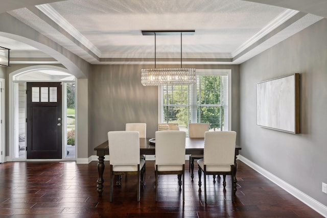 3365 Osgood Way N, Baytown Twp, MN 55082 - dining space featuring a chandelier, arched walkways, crown molding, wood-type flooring, and a raised ceiling
