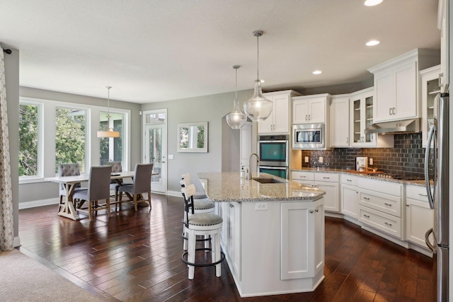 3365 Osgood Way N, Baytown Twp, MN 55082 - kitchen with appliances with stainless steel finishes, white cabinets, backsplash, light stone countertops, and recessed lighting