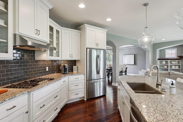 3365 Osgood Way N, Baytown Twp, MN 55082 - kitchen with appliances with stainless steel finishes, under cabinet range hood, arched walkways, dark wood-type flooring, and tasteful backsplash