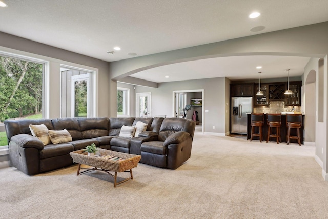 3365 Osgood Way N, Baytown Twp, MN 55082 - living room with arched walkways, light carpet, and recessed lighting