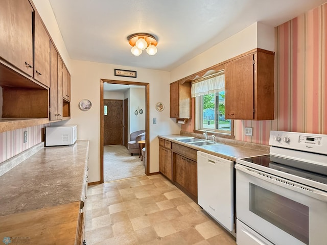 1737 14 1/2 St S, Fargo, ND 58103 - kitchen with white appliances and brown cabinets