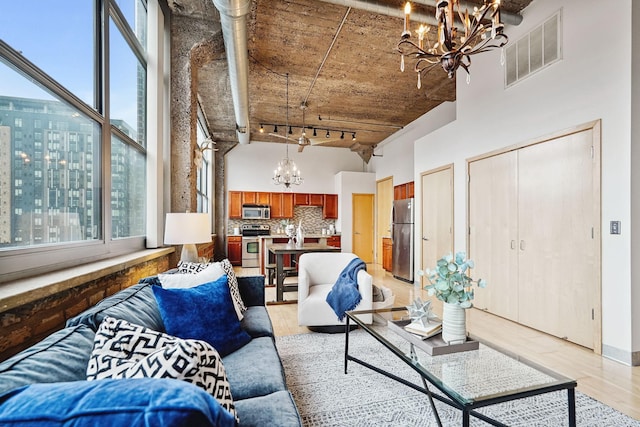 521 7th St Unit 420, Minneapolis, MN 55415 - living area with a chandelier, a high ceiling, and light wood-type flooring