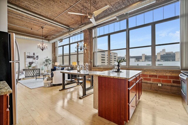 521 7th St Unit 420, Minneapolis, MN 55415 - kitchen featuring a chandelier, freestanding refrigerator, light wood-style flooring, ceiling fan, and decorative light fixtures