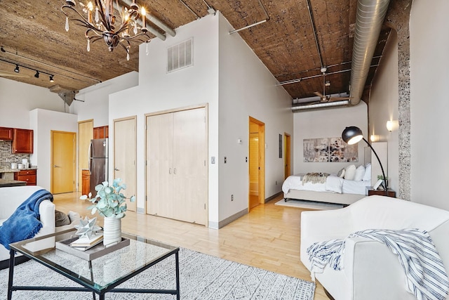 521 7th St Unit 420, Minneapolis, MN 55415 - living room with a towering ceiling, light wood-style flooring, a chandelier, and track lighting