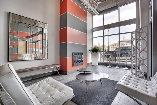 521 7th St Unit 420, Minneapolis, MN 55415 - living room with a high ceiling, wood finished floors, a chandelier, and floor to ceiling windows