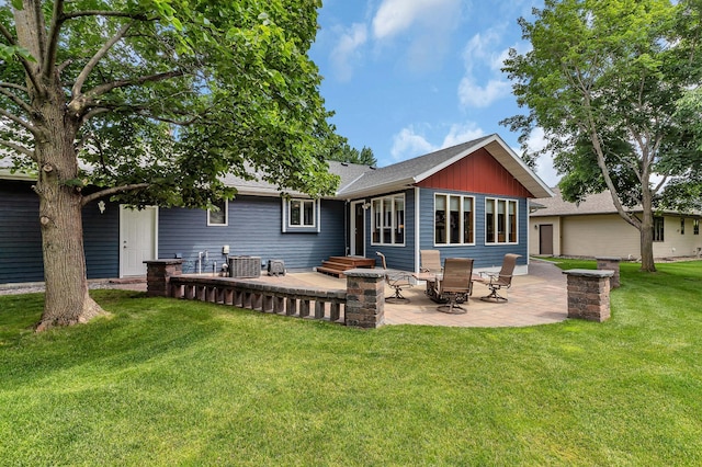 1213 4 1/2 Ave N, Sauk Rapids, MN 56379 - rear view of house featuring a patio, a lawn, and roof with shingles